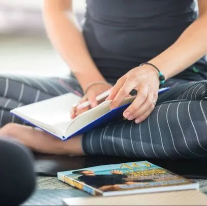 A journal open on a yoga mat