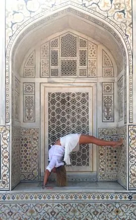 Lindsey in an arm balance in a carved marble doorway in Agra