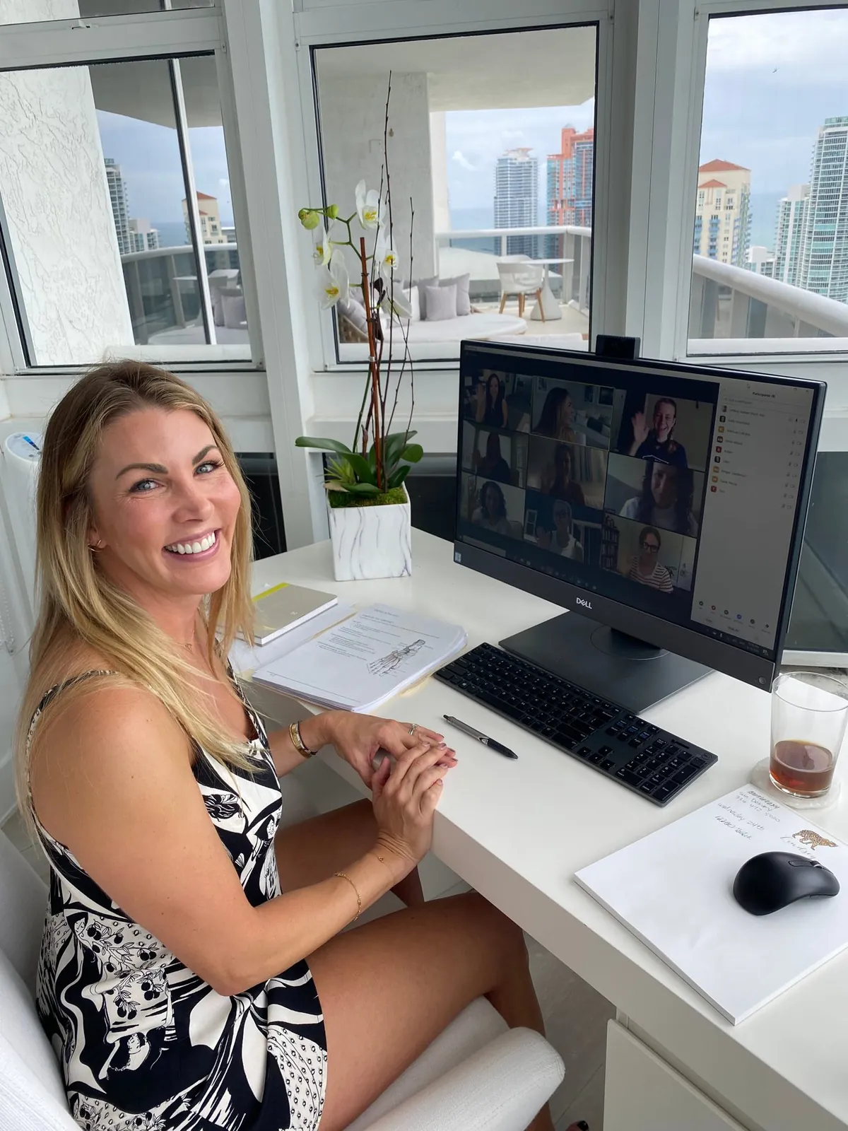 Lindsey smiling at her desk during a remote coaching session