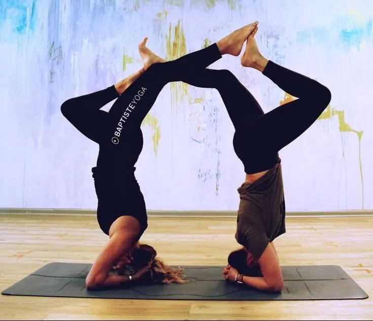 Two students in partner headstands